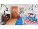 Bedroom boasts wood floors, natural light, and classic furnishings, offering a peaceful retreat at 1439 S Emerson St, Denver, CO 80210