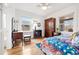 Bedroom featuring hardwood floors, lots of windows, and a mix of antique and classic furniture at 1439 S Emerson St, Denver, CO 80210