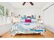 Bright bedroom features hardwood floors, ceiling fan, and a charming window with natural light at 1439 S Emerson St, Denver, CO 80210