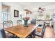 Dining area featuring a wooden table, chairs, and a view into the bright and modern kitchen at 1439 S Emerson St, Denver, CO 80210
