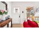 Bright entryway featuring a white front door, wooden table with flowers, and hardwood floors at 1439 S Emerson St, Denver, CO 80210
