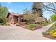 Charming brick home with a manicured front yard, blooming trees, and a welcoming entrance at 1439 S Emerson St, Denver, CO 80210