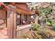 Inviting front porch with cozy seating, water feature, and charming brick details at 1439 S Emerson St, Denver, CO 80210