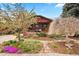 Charming brick home with a beautifully landscaped front yard and blossoming tree at 1439 S Emerson St, Denver, CO 80210