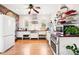 Bright kitchen with white cabinets, red countertops, stainless steel appliances, and hardwood floors at 1439 S Emerson St, Denver, CO 80210