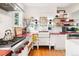 Bright white kitchen featuring farmhouse sink, stainless appliances, and open shelving for dishes and decor at 1439 S Emerson St, Denver, CO 80210