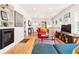 Bright living room with hardwood floors, a fireplace, comfortable seating, and a TV at 1439 S Emerson St, Denver, CO 80210