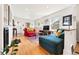 Bright living room features hardwood floors, stylish decor, and large windows at 1439 S Emerson St, Denver, CO 80210