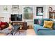 Bright living room with hardwood floors, comfortable seating, and a TV at 1439 S Emerson St, Denver, CO 80210
