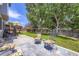 Backyard patio with wrought iron seating and beautiful, green lawn at 9890 Gaylord St, Thornton, CO 80229
