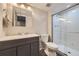 Modern bathroom with a double sink vanity and glass enclosed shower at 9890 Gaylord St, Thornton, CO 80229