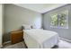 Bedroom with a comfortable queen bed, neutral color palette, and bright natural light at 9890 Gaylord St, Thornton, CO 80229