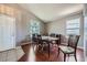 Bright dining room with hardwood floors, large windows, and a vaulted ceiling at 9890 Gaylord St, Thornton, CO 80229