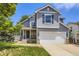 Charming two-story home featuring a stone facade, two-car garage, and well-manicured front lawn at 9890 Gaylord St, Thornton, CO 80229