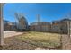Backyard with a trampoline, a grass area, and a stone border along the perimeter of the fence at 4774 Waldenwood Dr, Highlands Ranch, CO 80130