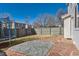 Fenced backyard featuring a trampoline, a stone patio, and some sparse grass at 4774 Waldenwood Dr, Highlands Ranch, CO 80130
