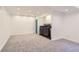 Spacious finished basement area with carpeting, lighting, laundry machines, and a blue door at 4774 Waldenwood Dr, Highlands Ranch, CO 80130