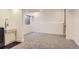 Basement featuring carpeting, a small window, lighting, and a wash basin at 4774 Waldenwood Dr, Highlands Ranch, CO 80130