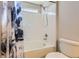 Cozy bathroom with a shower-tub combo and white tiled walls at 4774 Waldenwood Dr, Highlands Ranch, CO 80130