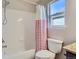 Bathroom featuring a shower-tub combo with white tiled walls at 4774 Waldenwood Dr, Highlands Ranch, CO 80130