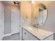 This half-bath offers a pedestal sink, updated mirror, and tiled floors at 4774 Waldenwood Dr, Highlands Ranch, CO 80130
