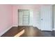 Bright bedroom with hardwood floors and a closet with drawers and shelving at 4774 Waldenwood Dr, Highlands Ranch, CO 80130