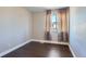 Bedroom featuring hardwood floors, neutral walls, and a curtained window at 4774 Waldenwood Dr, Highlands Ranch, CO 80130