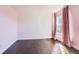 Bright bedroom featuring hardwood floors, neutral walls, and a large window at 4774 Waldenwood Dr, Highlands Ranch, CO 80130