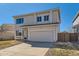 Charming two-story home with a red front door and well-maintained lawn in a residential neighborhood at 4774 Waldenwood Dr, Highlands Ranch, CO 80130