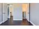 Hallway with hardwood floors and open doors leading to other rooms at 4774 Waldenwood Dr, Highlands Ranch, CO 80130