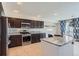 Modern kitchen with stainless steel appliances, granite countertops, and dark wood cabinetry at 4774 Waldenwood Dr, Highlands Ranch, CO 80130