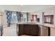 Open kitchen with granite island, stainless steel dishwasher, and lots of natural light at 4774 Waldenwood Dr, Highlands Ranch, CO 80130