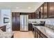 Updated kitchen boasts stainless steel appliances, granite countertops, and dark wood cabinetry at 4774 Waldenwood Dr, Highlands Ranch, CO 80130