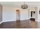Open-concept living area with hardwood floors, modern lighting, and kitchen access at 4774 Waldenwood Dr, Highlands Ranch, CO 80130