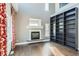 Bright living room features a cozy fireplace, built-in bookshelves, and stylish hardwood floors at 4774 Waldenwood Dr, Highlands Ranch, CO 80130