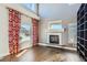 Sunlit living room with a fireplace, beautiful hardwood floors, and elegant curtains at 4774 Waldenwood Dr, Highlands Ranch, CO 80130
