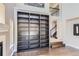 Open-concept living room boasts a large built-in bookcase and staircase leading to the second floor at 4774 Waldenwood Dr, Highlands Ranch, CO 80130