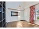 Well-lit living room with a mirror, stylish curtains, and hardwood floors creates a warm atmosphere at 4774 Waldenwood Dr, Highlands Ranch, CO 80130