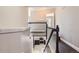 View of a staircase with dark hardwood floors and white banisters leading down to the kitchen at 4774 Waldenwood Dr, Highlands Ranch, CO 80130