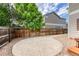 Private backyard with a decorative concrete patio, rock ground cover, and wood fence at 7345 S Nucla St, Aurora, CO 80016