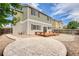 A backyard with stone patio, a small wood deck, rock ground cover, and a wood fence at 7345 S Nucla St, Aurora, CO 80016