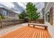 Fenced backyard featuring a wood deck, stone patio, and mature trees for a relaxing outdoor space at 7345 S Nucla St, Aurora, CO 80016