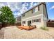 Backyard featuring a stone patio, wood deck, gravel, mature trees, and a privacy fence at 7345 S Nucla St, Aurora, CO 80016