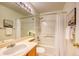 Bathroom featuring a shower-tub combination with shower curtain, and a sink at 7345 S Nucla St, Aurora, CO 80016