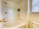 Bathroom featuring a clean white tub and shower combination, as well as a toilet at 7345 S Nucla St, Aurora, CO 80016