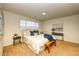 Bright bedroom with carpet flooring, queen bed, bedside tables, and a blue throw at 7345 S Nucla St, Aurora, CO 80016