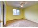 Bright bedroom with neutral carpet, window with blinds, and a ceiling fan with light at 7345 S Nucla St, Aurora, CO 80016