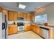 Well-equipped kitchen with stainless steel appliances, light wood cabinets, and ample counter space at 7345 S Nucla St, Aurora, CO 80016