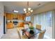 A bright kitchen with stainless steel appliances and a dining area with a chandelier at 7345 S Nucla St, Aurora, CO 80016