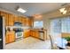Well-lit kitchen features stainless steel appliances, light wood cabinets, and a sliding door to the outdoor patio at 7345 S Nucla St, Aurora, CO 80016